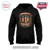 January 6th Never Forget It Was Treason Patriot black hoodie featuring a red, white, and blue shield emblem with stars.