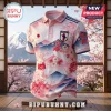 Japan themed polo shirt featuring cherry blossoms, Mount Fuji graphic, and national flag crest on a wooden stand.!
