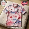 Japan polo shirt featuring pink cherry blossoms and mountain print, Japanese flag emblem, and navy blue sleeve stripes.!
