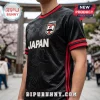 Black Japan soccer jersey with embossed crane and floral patterns, red sleeve trim, and Mt. Fuji logo emblem.!