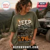 Olive green graphic t-shirt featuring a Jeep off-road vehicle illustration with 76 years of adventure text and fireworks.!