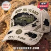 Jeep 85 years distressed baseball cap featuring an olive green SUV graphic, 1941-2026 text, and Trail Rated metal badges.!