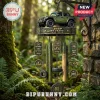 Jeep 85 years commemorative wind chime with olive green model SUV, tire accents, and metal tags in a forest setting.!