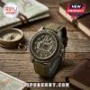 Jeep 95th anniversary wrist watch with olive green canvas strap, tire tread bezel, and Jeep grille dial on wood table.!