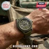Jeep 84th anniversary wristwatch with olive green dial, grille face detail, and canvas strap on a person's wrist.!