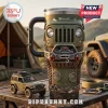 Olive green Jeep-themed travel tumbler with front grille, winch, and Trail Rated badge on a wooden camping table.!