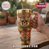 Gold stainless steel tumbler featuring a Jelly Roll skull graphic, wings, colorful roses, and Soul of Fire text.!
