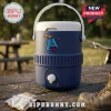 Blue plastic insulated water cooler with white lid, handle, and spigot featuring a cartoon bell and mallet graphic.!
