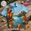Jimmy Buffett Margaritaville retired blue polo shirt featuring a parrot in sunglasses, tropical beach, and hibiscus print.