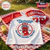 Nathan's Famous Hot Dog Eating Contest raglan t-shirt with red sleeves, graphic logo, and Chestnut jersey on picnic blanket.!