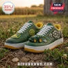Green and yellow leather sneakers with miniature tractor accent, yellow stitching, and 1837 emblem on cracked soil background.!