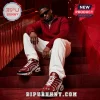 Man wearing red Kappa Alpha Psi themed sneakers with white soles sitting on red stairs in a burgundy cable-knit sweater.!