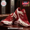 Kappa Alpha Psi crimson and white sneakers with Greek letters, 1911 text, and metallic emblem on a wooden surface.!