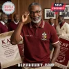 Kappa Alpha Psi Custom Name Polo Shirt in burgundy with embroidered crest, worn by a man with glasses in a formal office.