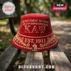 Red corduroy bucket hat with embroidered Kappa Alpha Psi text, Greek letters, crest, and Est. 1911 on a wooden bench.!