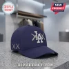 Navy blue baseball cap featuring a white Los Angeles Dodgers logo overlaid with grey X-stitch detailing on a granite top.!