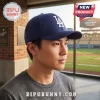 Navy Los Angeles Dodgers baseball cap with white LA embroidery worn by a man at a stadium.!