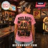 Pink t-shirt with back print of Kiss band performing on stage with tropical palm trees and concert graphic artwork.!