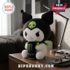 Kuromi Monster Energy Soft Plush Doll holding a black energy drink can on a wooden desk near a bedside lamp.