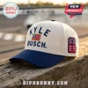 Kyle Busch baseball cap with cream crown, blue brim, American flag embroidery, and number 8 patch on a wooden fence.!