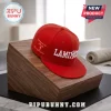 Lamine Yamal New York Yankees red snapback hat with white embroidery resting on a slanted wood display block.