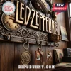 Led Zeppelin Embossed Vintage Metal Wall Key Rack featuring metallic band logo, guitar, and airship icons on wood wall.