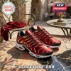 Liverpool FC themed athletic sneakers in red and gold satin fabric with white foam midsoles on a stone table.!
