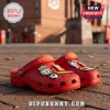 Red foam clogs featuring Liverpool Football Club logo, YNWA text, and soccer ball charms on a brick outdoor background.!