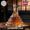 Minas Tirith glass decanter filled with amber liquid, featuring a white tree stopper on a wooden table surface.!