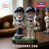 Los Angeles Dodgers Dia De Los Muertos sculpted bobblehead featuring two figures in team uniforms on a grass base.
