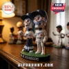 Los Angeles Dodgers Dia De Los Muertos sculpted bobblehead featuring two sugar skull characters in team uniforms.