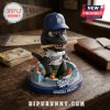 Los Angeles Dodgers Godzilla Minus Zero sculpted figurine wearing a team jersey and baseball cap with a bat in its mouth.