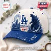 Los Angeles Dodgers x Godzilla 2026 blue baseball cap featuring a city skyline, full moon, and monster illustration.