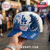 Los Angeles Dodgers x Godzilla 2026 blue baseball cap featuring a city skyline, full moon, and monster graphic on white.