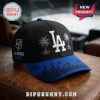 Los Angeles Dodgers x Los Angeles Kings black adjustable cap with white LA logo, palm trees, and blue skyline brim.