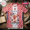 Luka Modric tribute jersey featuring red and white checkered pattern, player photos, and text End of an Era on wooden desk.!