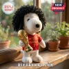 Marc Cucurella Spain Snoopy plush toy wearing a red soccer jersey, black curly hair, and holding a gold World Cup trophy.