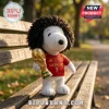 Marc Cucurella Spain Snoopy plush toy with curly hair wearing a red number 3 jersey and holding a gold trophy on a bench.
