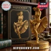 Gold Marilyn Monroe vinyl figure on a circular base beside a black box marked 100th Anniversary.!