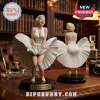 Two Marilyn Monroe resin statues wearing white pleated dresses on circular black bases with 100th anniversary nameplates.!