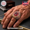 Marvel Spider-Man 64th Anniversary Ring featuring a central red gemstone with black spider logo on a gold and blue band.