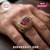 Marvel Spider-Man 64th Anniversary ring featuring a red gemstone, central spider emblem, and gold-tone metallic filigree.