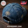 Masonic Friendship 1717-2026 Distressed Denim Baseball Cap with gold embroidered eye motifs on a dark leather background.