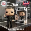 Agent K vinyl figure holding a neuralyzer next to a 30th anniversary Men in Black display box on a dark surface.!