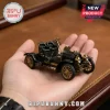 Mercedes 35 PS 125th Anniversary Die-Cast Model Car in black and gold held in a person's palm against a desk background.