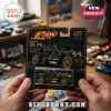 Mercedes 35 PS 125th Anniversary Die-Cast Model Car in black and gold packaging held by hands on a blurred hobby table.