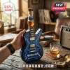 Metallica Ride the Lightning themed electric guitar shaped glass whiskey bottle with blue lightning graphics on wood table.!
