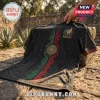 Black Mexico soccer jersey with Aztec sun stone patterns, green and red geometric center stripe, and gold Mexico emblem.!