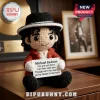 Michael Jackson crochet amigurumi doll wearing a red jacket and fedora, holding a sign with You are not alone lyrics.!