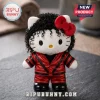 Hello Kitty plush wearing a red leather Thriller-style jacket, black curly wig, and red hair bow on a dark slate surface.!